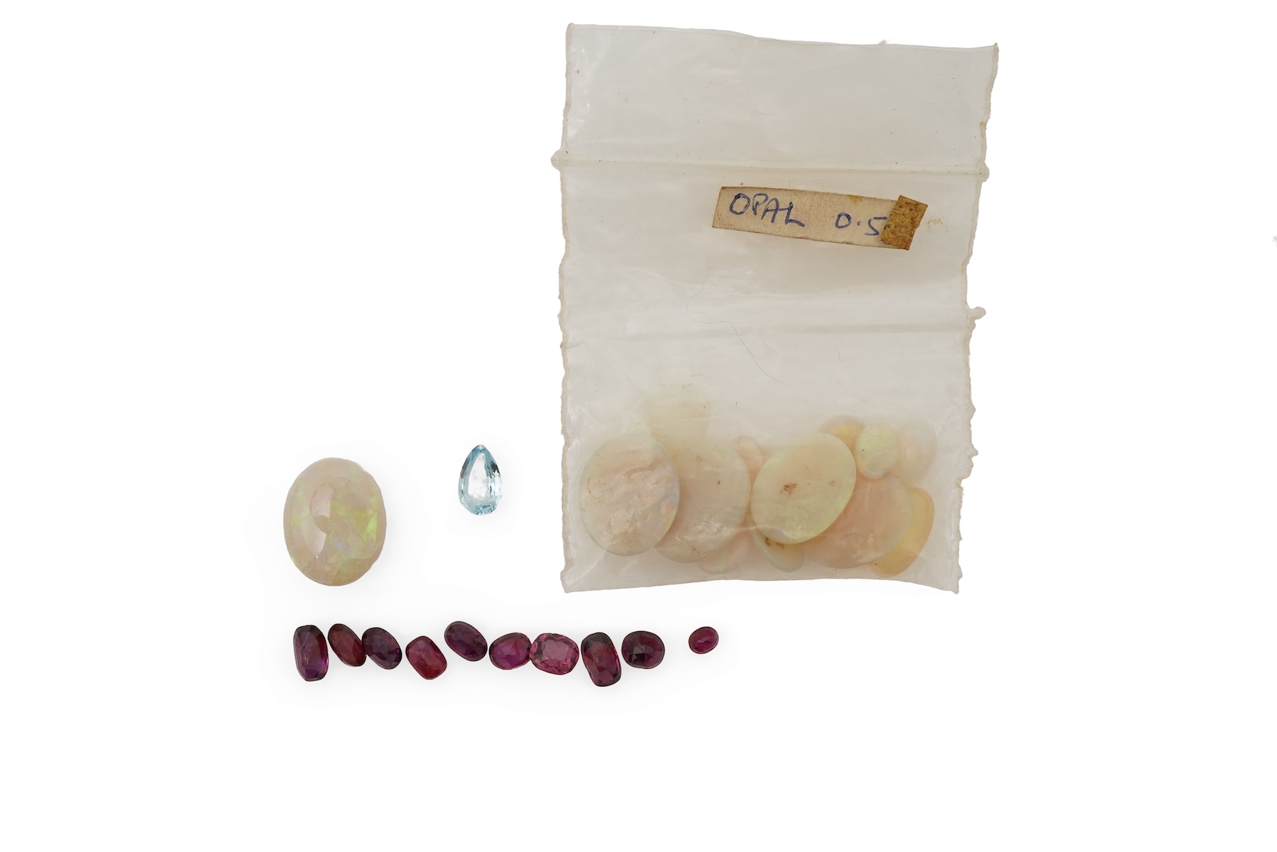 A collection of loose rubies, aquamarines and opals